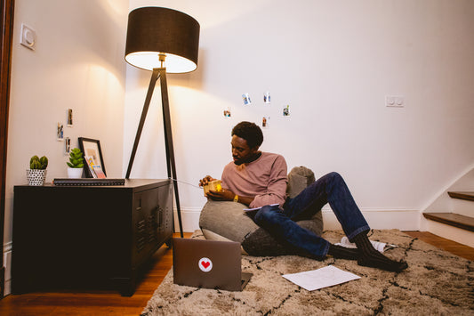 Man opening a gift from his friend before going away to college.