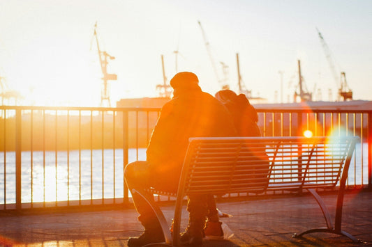 A man seat on a bench