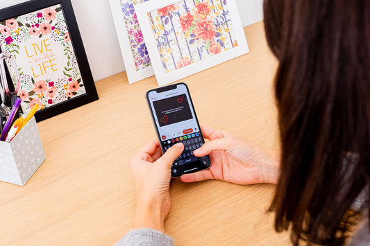 A woman using the Lovebox app to write a love letter.